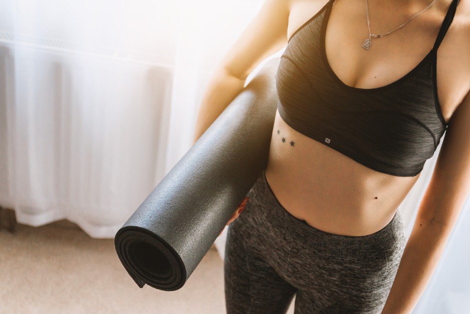 young woman with yoga mat